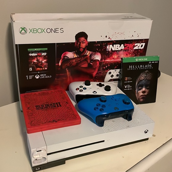 Xbox one S 1 T, with 2 controllers, 2 games, and a rechargeable battery.